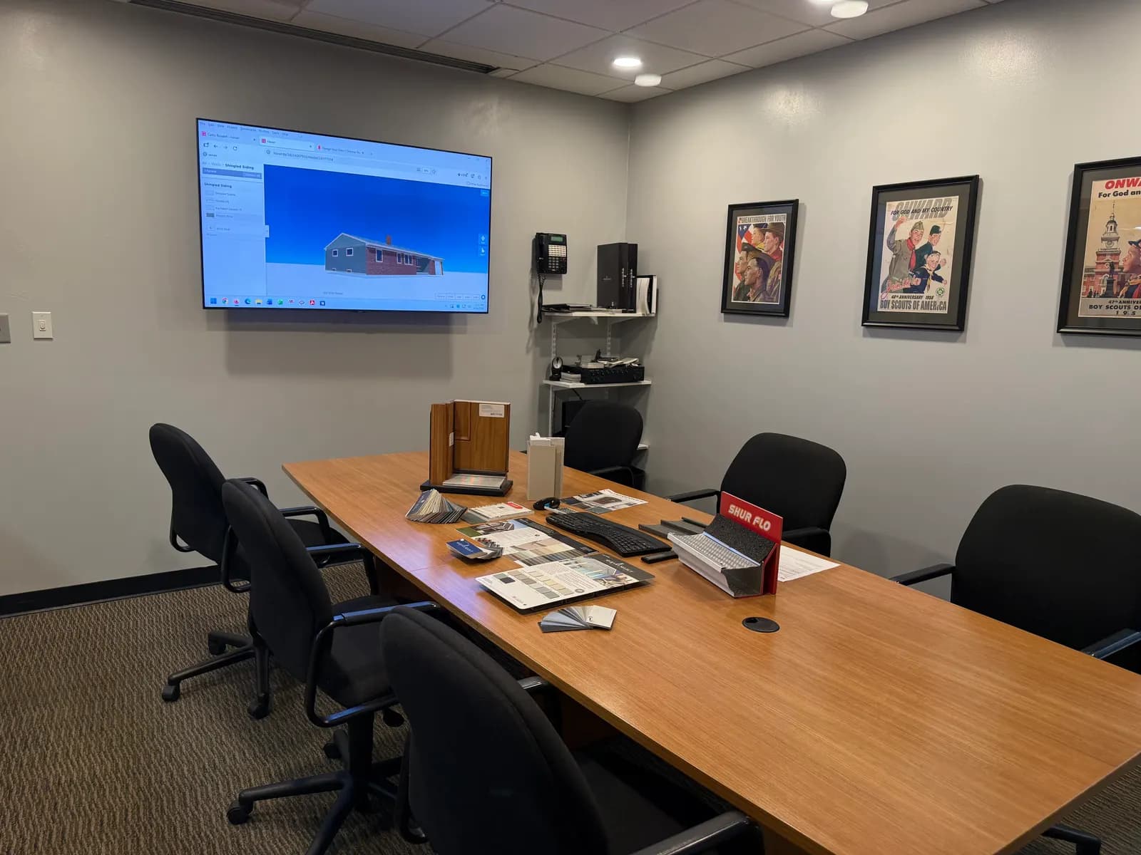 Conference room with samples and a 3D house model on screen