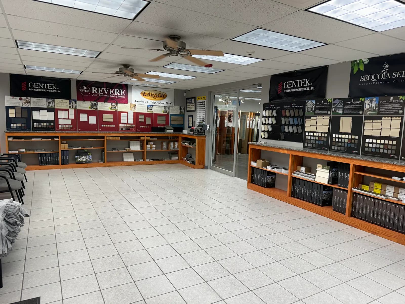 Siding sample wall with cabinets of sample books